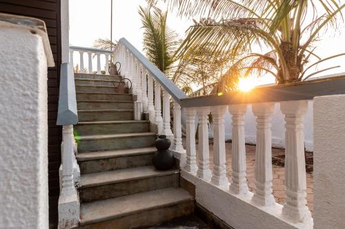 a staircase leading to a house with the beach at The Hammock Goa in Anjuna