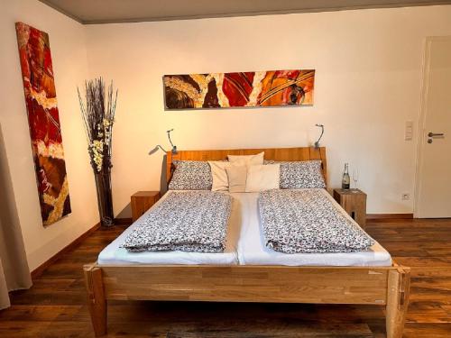 a bedroom with a wooden bed with two pillows at Ferienwohnung Familie Nachtmann in Beilngries