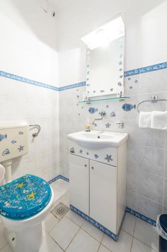 a bathroom with a toilet and a sink and a mirror at Apartment Soulmate in Dubrovnik