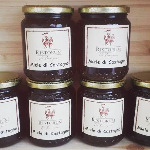 a group of three jars of jam on a shelf at Villa Marinsky Pietrasanta , Lucca in Pietrasanta
