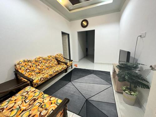 a living room with a couch and a tv at Sara Homestay 1 & Sara Homestay 2 in Marang