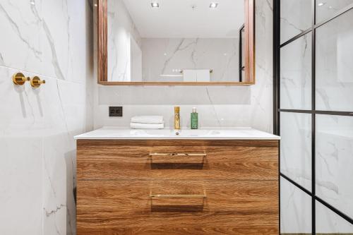 a bathroom with a sink and a mirror at Enter St Elisabeth Suites & Spa in Tromsø