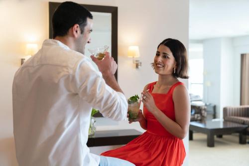 a man and a woman eating food and drinking wine at lebua at State Tower in Bangkok