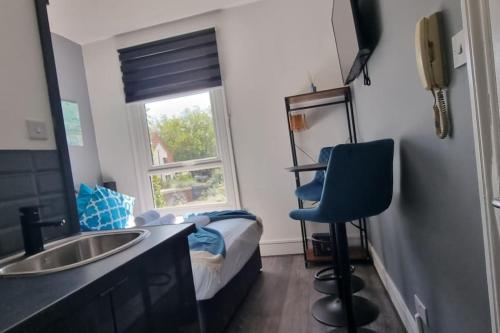 a bathroom with a sink and a bedroom with a bed at Contemporary Studio Haven l 1Bed 1 Bath in London in London