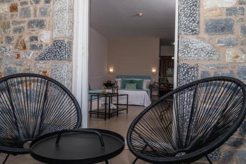 two chairs and a table in a room at Diamond Palace in Gythio