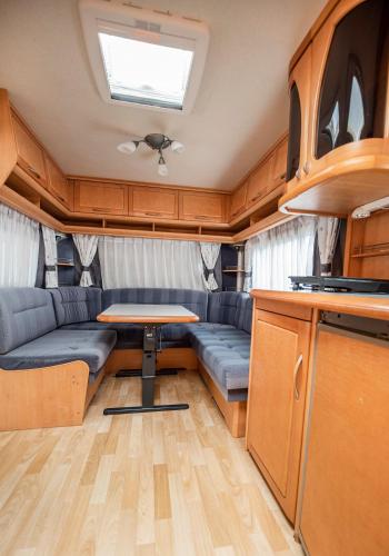 a living room with a table in a trailer at Maszoperia Sun4hel Kite & Wind & Surf in Jastarnia