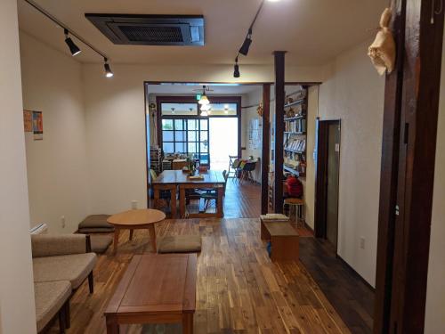 a living room with a couch and a table at Guesthouse Tomaru in Takayama