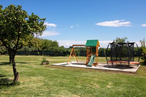 a park with a playground with a swing at La Lagunilla Golf in Candeleda
