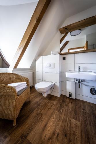 a bathroom with a sink and a toilet at Gutshof Bastorf in Kühlungsborn