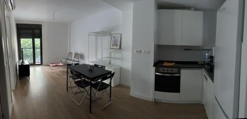 a kitchen with a table and a stove in a room at Mars Suites Porras in Madrid