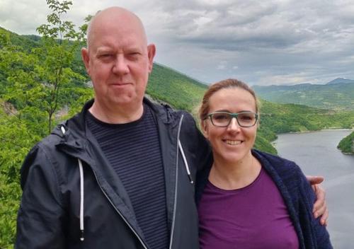 a man and a woman standing in front of a river at Haus Viktoria near Banja Luka in Banja Luka