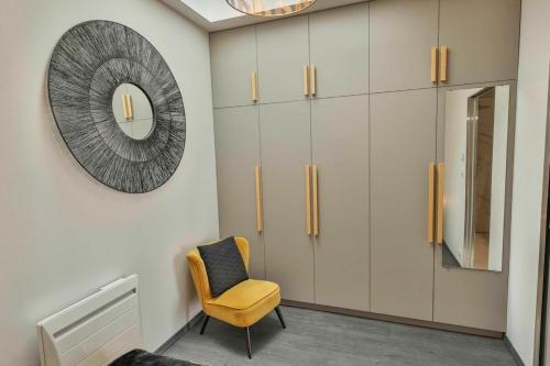 - un dressing avec une chaise et un miroir dans l'établissement Domaine Grand Piquecaillou - L'appartement Cerons, à Saint-Maixant