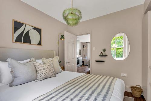 a bedroom with a large white bed and a window at Be London - The St John's Wood Residences in London