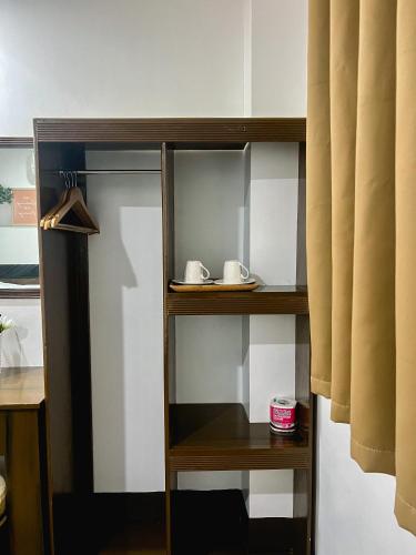 a wooden shelf with two mugs on it at Island Wanderers Inn in Coron
