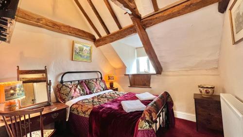 a bedroom with a bed and a table and a window at Cosy Cottage in Wellington