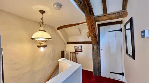 a hallway with a white door and a ceiling at Cosy Cottage in Wellington