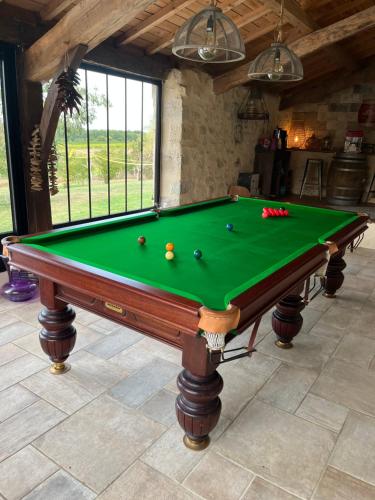 a pool table with balls on it in a room at La chambre l'Eucalyptus in Saint-Laurent-du-Bois