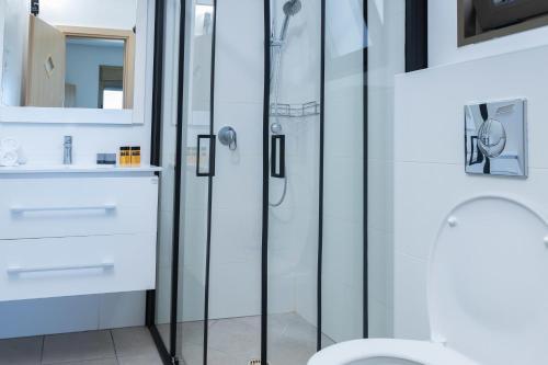 a bathroom with a shower and a toilet at O&O Group - SeaFront Luxurious 3 BR Apartment in Bat Yam