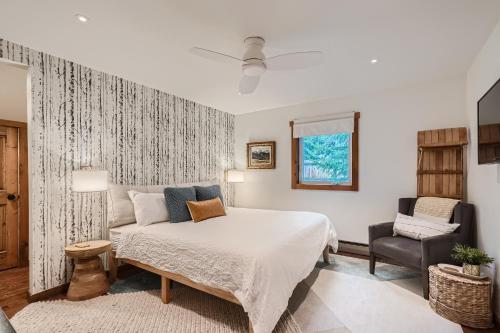 a bedroom with a large bed and a chair at Trollhagen 5 Condo in Breckenridge
