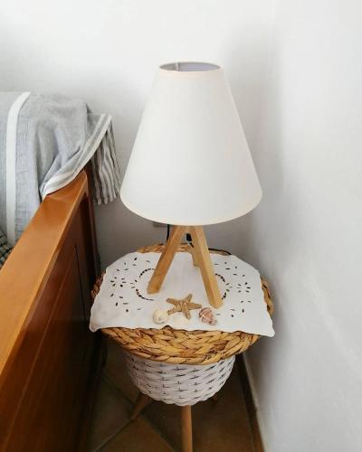 a table with a lamp on top of a basket at Votsalo Apartments in Naousa