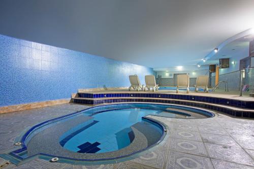 a large swimming pool in a hotel room at Sadeen Amman Hotel in Amman