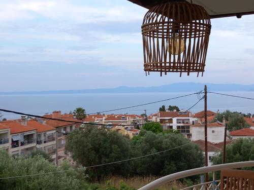 a bird cage hanging over a city with buildings at Χαλκιδική Κρυοπηγή in Kriopigi