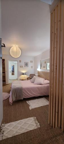 a bedroom with a large bed in a room at EMA Cottage in Montjean