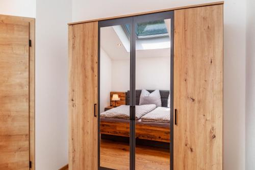 a glass door in a bedroom with a bed at Ferienwohnung Rosalie in Farchant