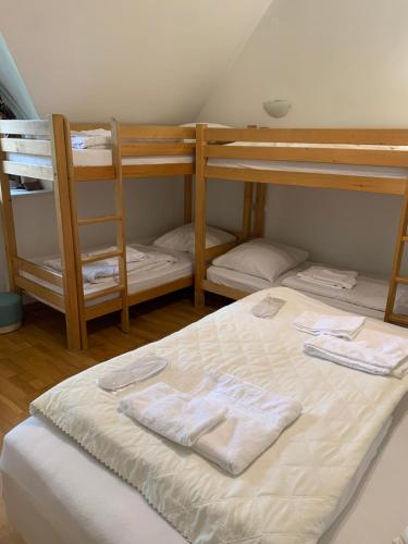 a bedroom with two bunk beds with towels on a bed at Pokoje Sunshine World Suites in Zakopane