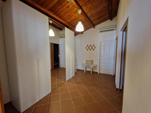 un pasillo con paredes blancas y suelo de baldosa marrón en Villetta d' aMare, en Avola
