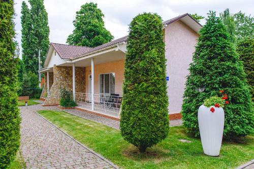 a house with trees in front of it at Sovinyon Resort in Odesa