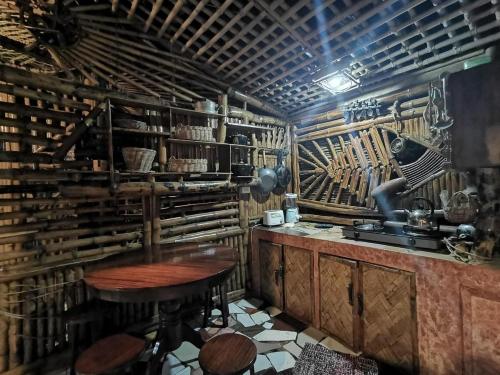 a kitchen with a counter and a table in a room at Bamboo Nest in Puerto Princesa City
