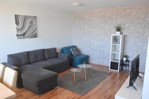 a living room with a couch and a tv at Panorama View Apartment in Veszprém