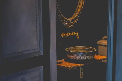 a room with a mirror and a bowl on a table at Le Petit Chateau & William de Percy in Otterburn
