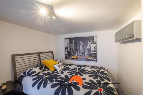 a bedroom with a bed with a flower patterned comforter at #041 Future House by Home Holidays in Albufeira