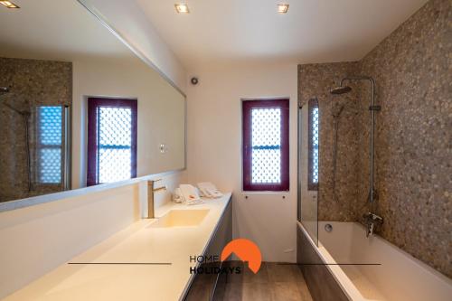 a bathroom with a shower and a sink and a tub at #041 Private Beach View, High Speed WiFi, 20 mts Beach in Albufeira