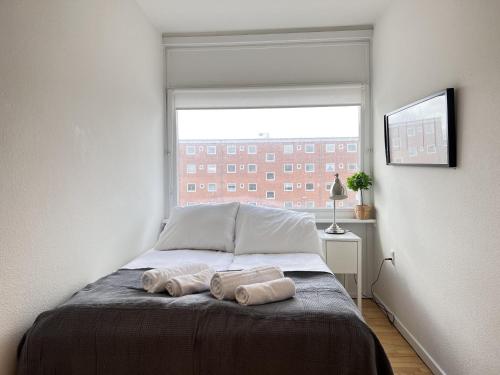 a bedroom with a bed with two towels on it at Apartment In Valby in Copenhagen