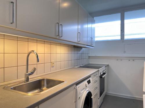 a kitchen with a sink and a dishwasher at Apartment In Valby in Copenhagen