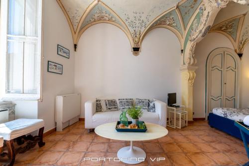 a living room with a white couch and a table at Papù 2 by PortofinoVip in Portofino