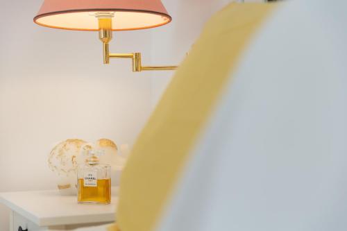 a bottle of whiskey sitting on a table next to a lamp at Naxos Beach Front Villa ''Moments'' in Ambrami