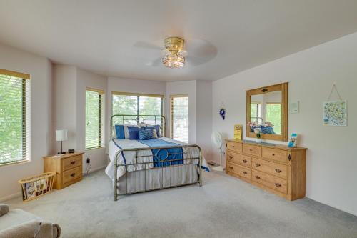 a bedroom with a bed and a dresser and a mirror at Charming Elko Home with Pool Table! in Elko