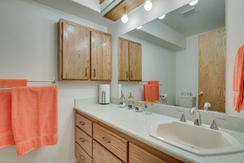 a bathroom with a sink and a mirror at Charming Elko Home with Pool Table! in Elko