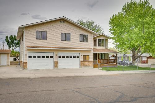 a house with two garage doors on a street at Charming Elko Home with Pool Table! in Elko