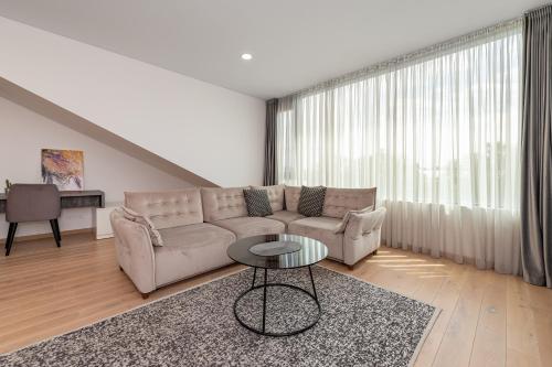 a living room with a couch and a table at Spaciuos 1 BD Apt by Hostlovers in Kaunas