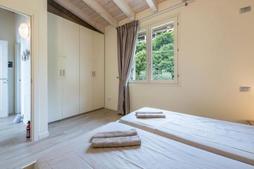 a bedroom with a large bed with two pillows on it at Little Paradise Lake Garda in Toscolano Maderno