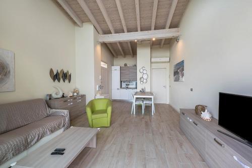 a living room with a couch and a table at Little Paradise Lake Garda in Toscolano Maderno