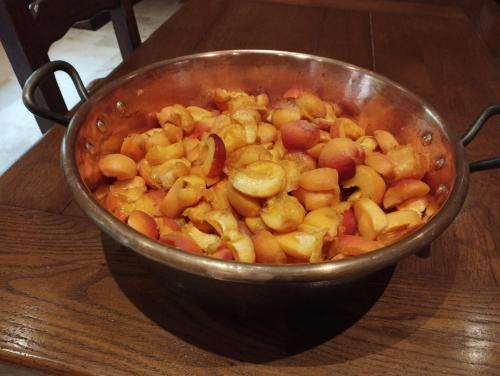 a metal pot of food on a wooden table at LES CHAMBRES DE LIANE in Cerdon