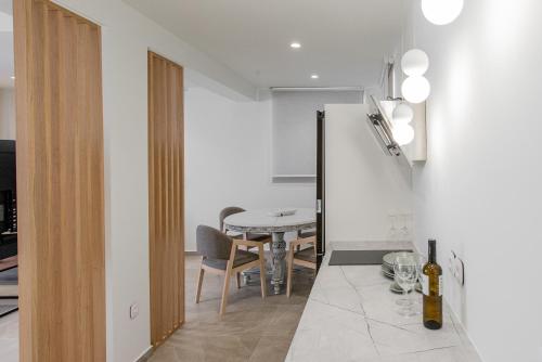 a kitchen and dining room with a table in a room at Gemela AllstarBoutique in Aegina A in Aegina Town