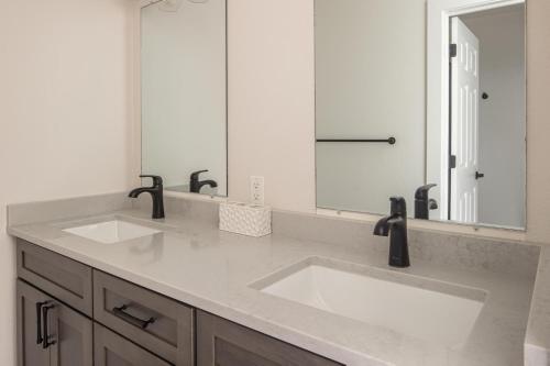 a bathroom with two sinks and a large mirror at Firelight Chalet 106 Candlelight Meadows in Big Sky