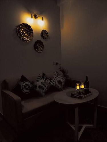 a living room with a couch and a table with candles at Dubai Suite by Hey Studios in Ghaziabad